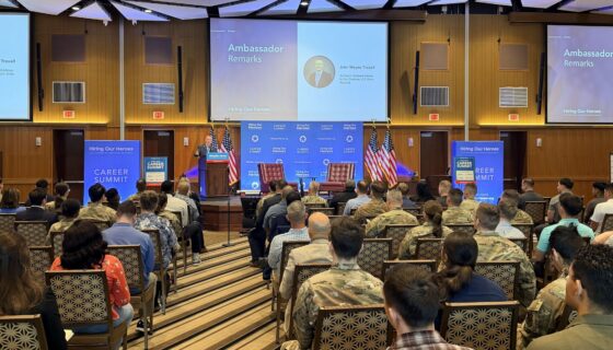 Ambassador John Wayne Troxell delivers remarks to an audience of service members and civilians at the 2026 Career Summit at Kadena Air Force Base.
