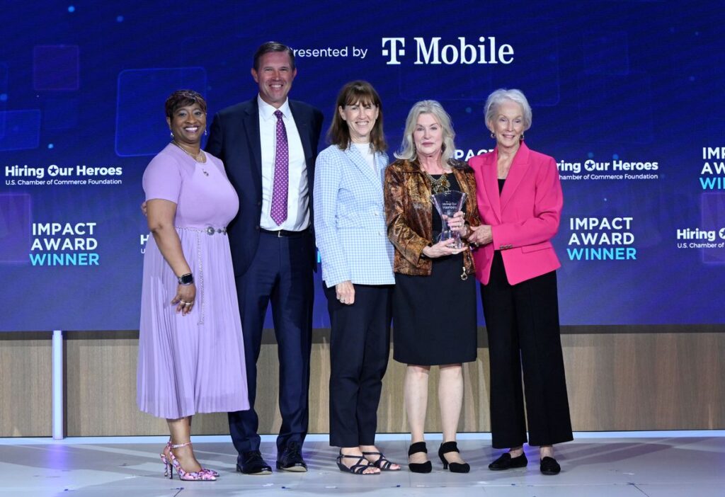 Five people including Eric Eversole, Bonnie Amos, and Deb Kloeppel pose with the Bonnie Amos Impact Award for Lifetime Achievement.