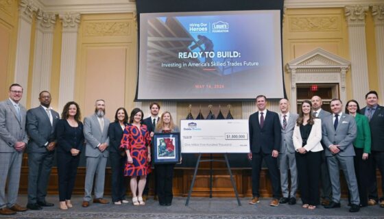 Representatives from Lowe's Foundation and Hiring Our Heroes pose with a $1.5M commemorative check during a historic grant ceremony.