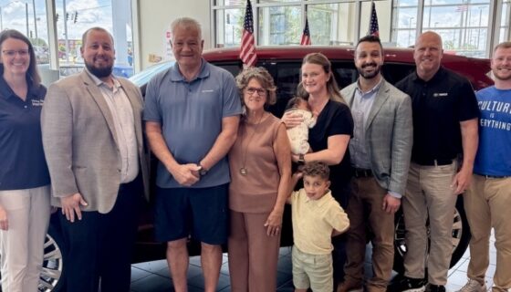 2026 winner Steve Lawrence posing with his family and representatives from the Toyota dealership and Hiring Our Heroes in front of his new Toyota Highlander.